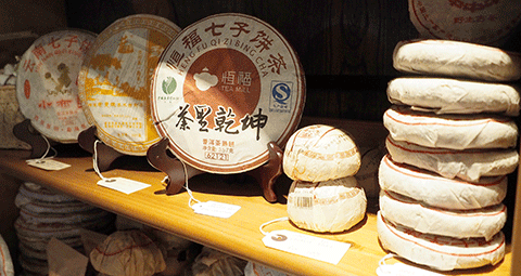 Cakes of Pu-erh line the shelves of Juyan Chinese Tea Shop along Portobello Road in London.